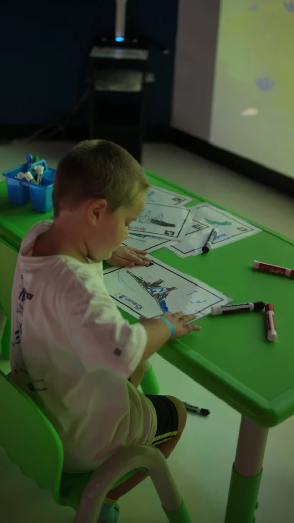 A child interacts with interactive animated drawings