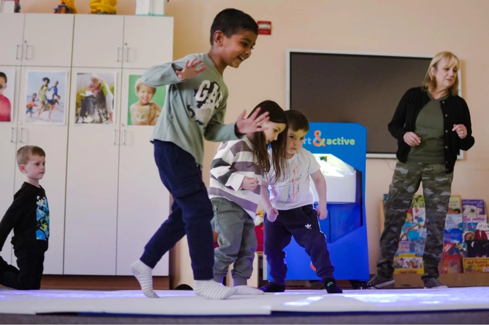 Kids interacting with interactive equipment