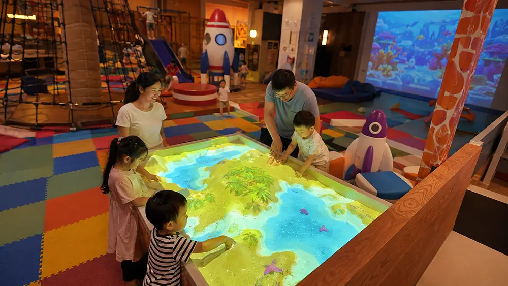 Family playing with interactive sandbox