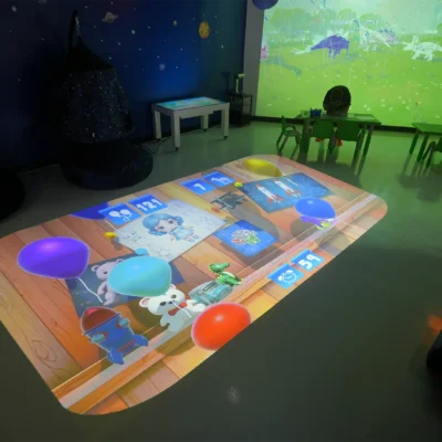 Interactive floor projector displaying educational games in a children's learning and activity room
