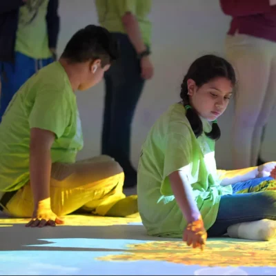Children interacting with colorful educational games projected onto an interactive floor