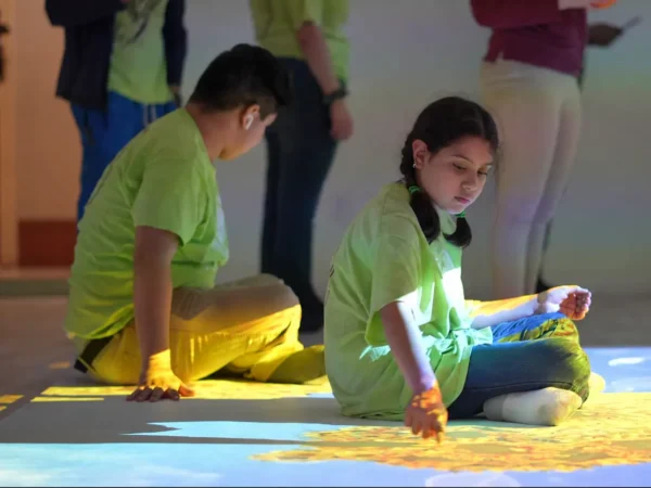 Children interacting with colorful educational games projected onto an interactive floor