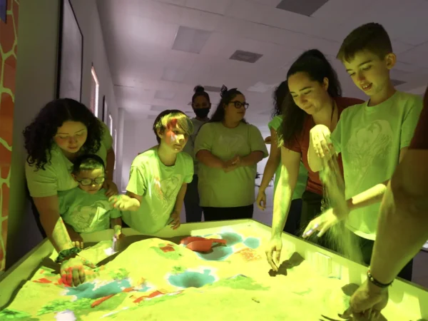 Students exploring an interactive AR sandbox through hands-on sensory learning