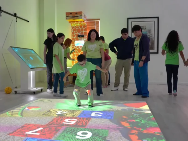 Students using a movement-based learning game on the interactive floor